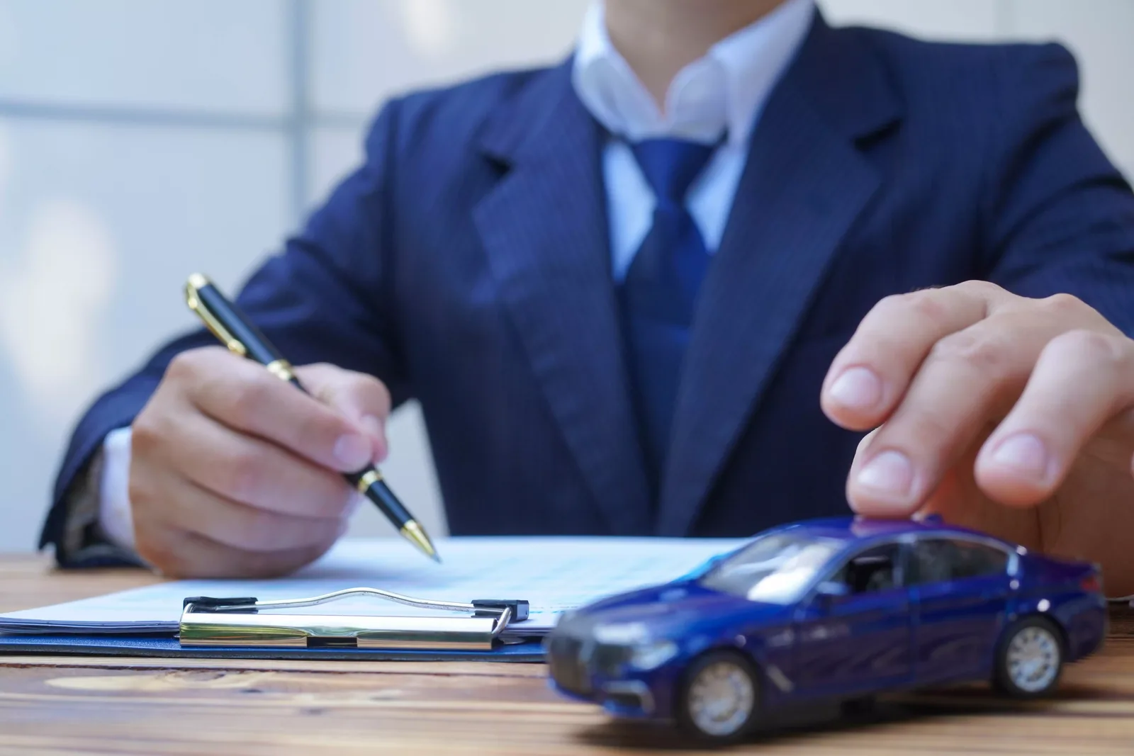 Finance manager reviewing an auto loan refinancing agreement